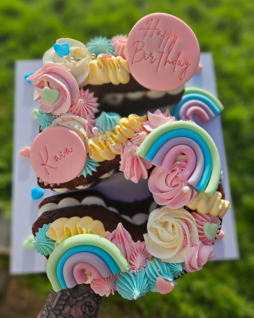 Number five cupcake cake with pastel rainbows