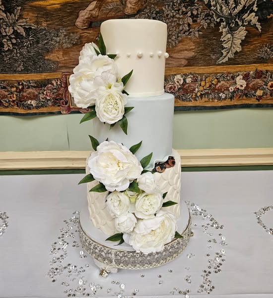 Fondant floral cake with peeking dogs